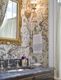 a bathroom with a sink and mirror next to a curtained window on the wall