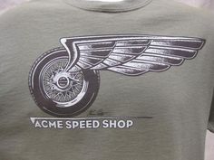 a green t - shirt with the words acme speed shop on it's front