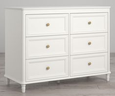 a white dresser sitting on top of a wooden floor