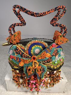 This vintage Mary Frances purse is a rare find, featuring a colorful and beautifully beaded jeweled butterfly. The satchel/top handle style is perfect for everyday use and the snap closure ensures your belongings stay secure. The multicolor exterior is made of a cotton blend with beaded accents, while the black lining is made of fabric. This purse is a unique addition to any collection, with a fun and playful butterfly theme. The small size and beaded handle/strap make it easy to carry and add a touch of vintage charm to any outfit. Made in France, this Mary Frances purse is a must-have for any fashion-forward woman. Mary Frances Purses, People Artwork, Butterfly Purse, Mary Frances Bags, Upcycled Purse, Mary Frances, Floral Purse, Butterfly Theme, Beaded Purses