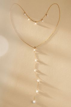 Like a trickling waterfall, this cascading necklace effortlessly flows down your back. You’ll want to don a silhouette with an open back to highlight this piece’s tiny pearls. | Cascade Back Necklace by TEMPÊTE in Gold, Women's, Gold/Freshwater Pearl at Anthropologie Diy Back Necklace, Bohemian Bridal Jewelry, Luxury Gold Lariat Backdrop Necklace, Elegant Adjustable Gold Bridal Necklace, Delicate Gold Drop Backdrop Necklace, Minimalist Pearl Drop Lariat Backdrop Necklace, Delicate Gold Long Drop Backdrop Necklace, Pearl Back Necklace, Pearl Necklace Diy