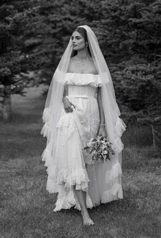 black and white photograph of a woman in a wedding dress with veil over her head