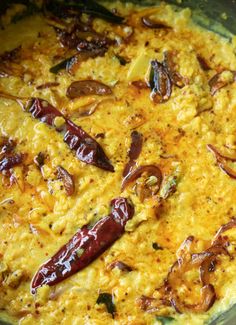 an omelet with red peppers and onions on it in a glass bowl, ready to be eaten