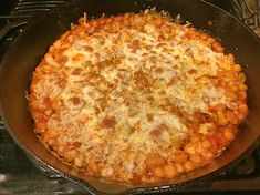 a pizza sitting on top of a pan covered in cheese