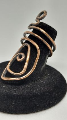 Hand-crafted adjustable ring made out of copper and dipped in liver of sulfur. Rust Adjustable Jewelry For Gifts, Adjustable Rust-colored Jewelry Gift, Handmade Copper Spiral Rings, Handmade Copper Artisan Ring, Artisan Copper Ring Jewelry, Adjustable Copper Metal Ring Jewelry, Unique Bronze Copper Rings, Unique Handmade Copper Rings, Bronze Copper Open Ring