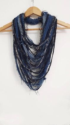 a blue scarf hanging on a wooden hanger