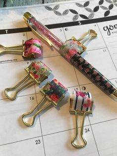 three hair clips sitting on top of a calendar