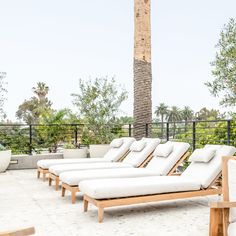 the lounge chairs are lined up on the patio