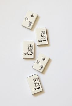 four rubber stamps with drawings of boots and stars on them, sitting on a white surface