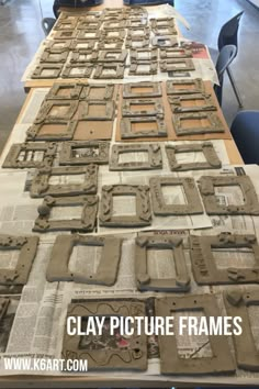 several pieces of clay sitting on top of a table covered in newspaper strips and frames