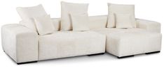 a white couch with four pillows on it's back and two sides facing each other