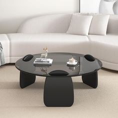 a living room with a white couch and black coffee table in front of the sofa