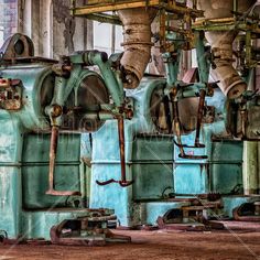 an old factory with several large machines in the process of being used for industrial purposes