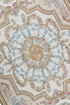 an elaborately decorated ceiling in the shape of a flower and bird design, with gold accents