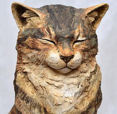 a statue of a cat with its eyes closed