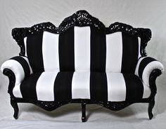 a black and white striped couch sitting on top of a table