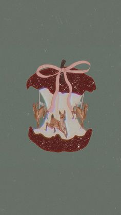 an ornament with deer and ribbon hanging from it's side on a gray background