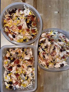 three plastic containers filled with food on top of a wooden table