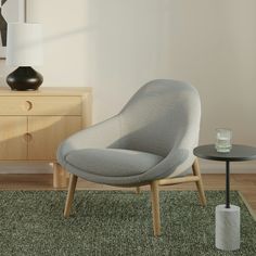 a living room scene with focus on the chair and side table in the foreground