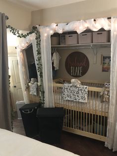 a baby's room decorated with white curtains and lights