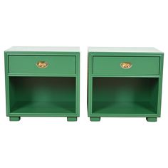 two green nightstands side by side with gold handles on each drawer and one is open