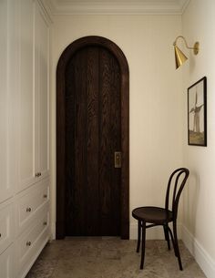 a chair sitting in front of a wooden door