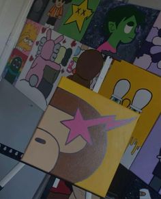 many cartoon pictures are on the wall with one pink star in the middle and two green stars at the bottom