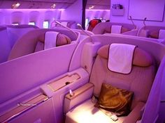 the inside of an airplane with purple lighting