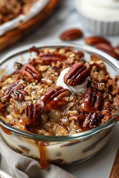 a dessert dish with pecans and whipped cream