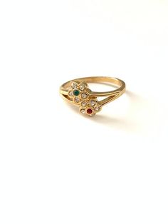 Vintage Dainty Red Green Clear Rhinestone Crystal Flower Ring, Vintage Gold Tone Flower Stacking RingSweet dainty new old stock flower rings, in very good vintage condition. All items such as boxes, coins, etc., in photos are NOT included with the jewelry, they are props being used for display. Important: Please read all shop policies prior to purchase.The below is a brief overview, to view full shop policies please go to the homepage of the shop and scroll to the bottom and they are listed in f Vintage Wedding Toe Ring With Flower Design, Vintage Wedding Flower Toe Ring, Vintage Gold Jeweled Rings, Vintage Multi-stone Birthstone Promise Ring, Vintage Flower Toe Ring Gift, Vintage Flower Toe Ring As Gift, Vintage Flower Toe Ring For Gift, Vintage Flower Toe Ring, Vintage Multi-stone Birthstone Ring As Gift