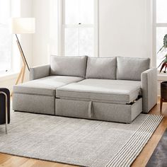 a living room scene with focus on the couch and storage compartment under the armrests