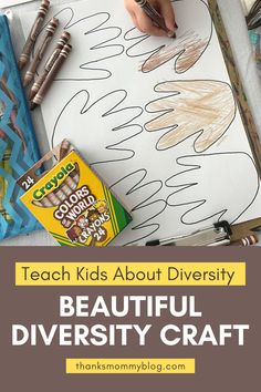 a child's hand is drawing on a piece of paper with crayons