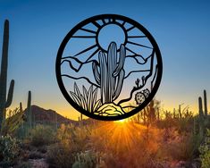 the sun is setting behind a large metal cactus sign in the middle of a desert