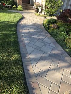 a brick walkway in front of a house