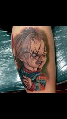 a tattoo on the leg of a person with a creepy face and clown makeup painted on it