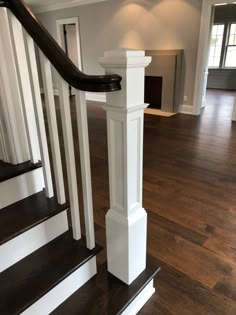 an empty house with wood floors and white railings