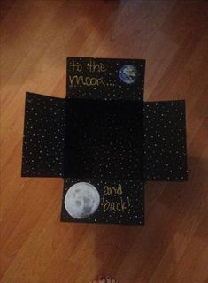 a child's feet are standing on the floor in front of a black box that says, to the moon and back