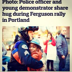 a man is hugging another man on the street with other people in the back ground