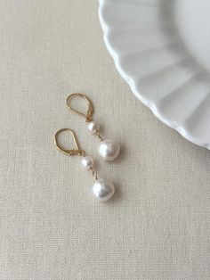 Never underestimate the power of a simple pearl drop earring! These double baroque pearl earrings look as beautiful on your special day as they do glamming up any casual outfit. They are sure to become a favorite go to accessory! * Natural 6mm and 10mm off-round white Baroque Pearls * 14K Gold Filled or 925 Sterling Silver 17mm Leverback clasp * 1.5 inch length * Made with all hypoallergenic materials 🤍 *Please note for the health and safety of my customers, and to uphold the highest quality standards - these earrings are final sale - please dm me with any questions prior to purchase 😊 ✨ Shop all Pearl earrings here!: https://etsy.me/3Xiy4c5 GET TO KNOW MAGBEE JEWELRY! ✨  🤍 All MagBee pieces are safe for sensitive skin and made with hypoallergenic Gold Filled or 925 Sterling Silver. 🤍 Simple Pearl Earrings, Bridal Pearl Earrings, Pearl Drop Earrings Bridal, Freshwater Pearl Drop Earrings, Earrings Double, Simple Pearl, Basic Jewelry, Baroque Pearl Earrings, Bridal Earrings Pearl