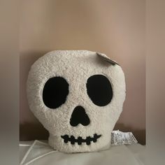 a white stuffed skull sitting on top of a table