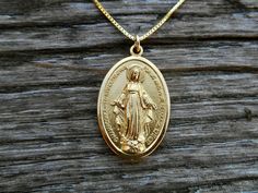 "XL Gold Tone Miraculous Medal, Medal of the Immaculate Conception, Tall, Oval-Shaped Miraculous Medal. Extra large version. Die cast in Italy for exceptional detail. 'O Mary Conceived without Sin Pray for Us who have Recourse To Thee'. The extra large size of this piece brings out every detail of its beautiful design. Made in Italy. Measures 1 1/4\" 18\" Gold Plate over Solid Sterling Silver Box chain made in Italy with 10mm rectangular clasp. 18 gauge jump rings! Comes in a gift box, ready for Miraculous Medal Necklace, Saint Necklace, The Immaculate Conception, Pretty Jewelry Necklaces, Immaculate Conception, Bangles Design, Heavy Chain, Gold Bangles Design, Pray For Us