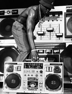 a man standing on top of a boom box