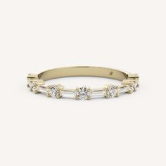 a yellow gold band with three stones on the side and two diamonds in the middle