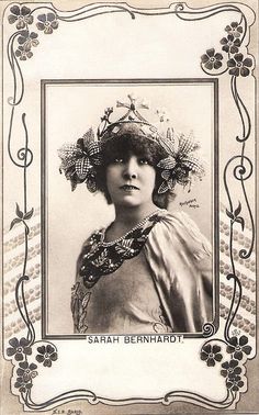 an old photo of a woman wearing a headdress with flowers in her hair