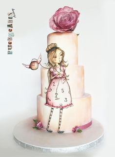 there is a cake decorated with a girl and a bird on it's side