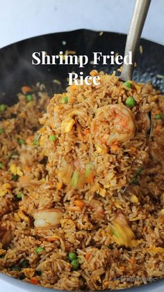 shrimp fried rice in a skillet with a spoon