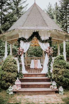 a gazebo decorated with flowers and greenery