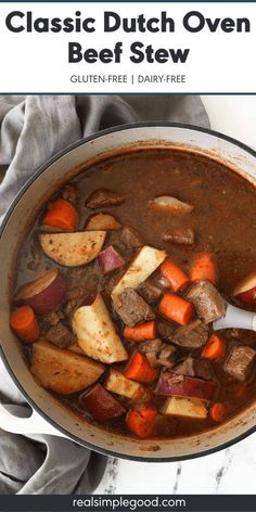 a pot full of beef stew with carrots and potatoes