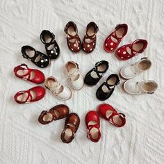 many pairs of shoes are arranged in a circle on a white surface, with the bottom half showing