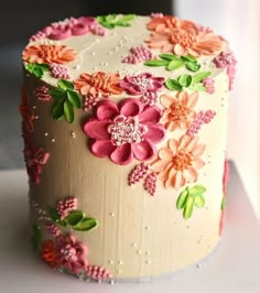 a decorated cake sitting on top of a white table